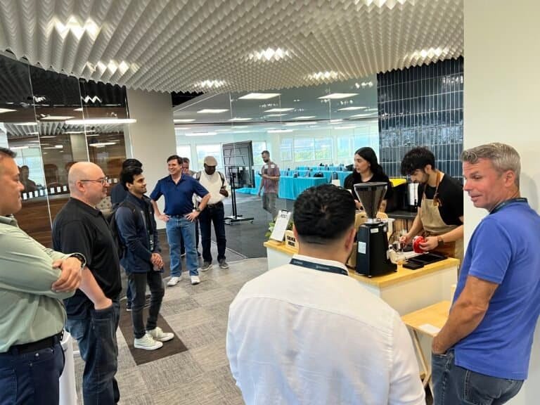 Coffee tasting event at Sunny Cups Coffee shop, with customers and staff engaging.