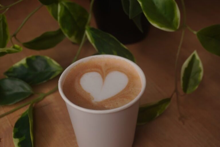 Close-up of a latte with a heart-shaped foam art on top.