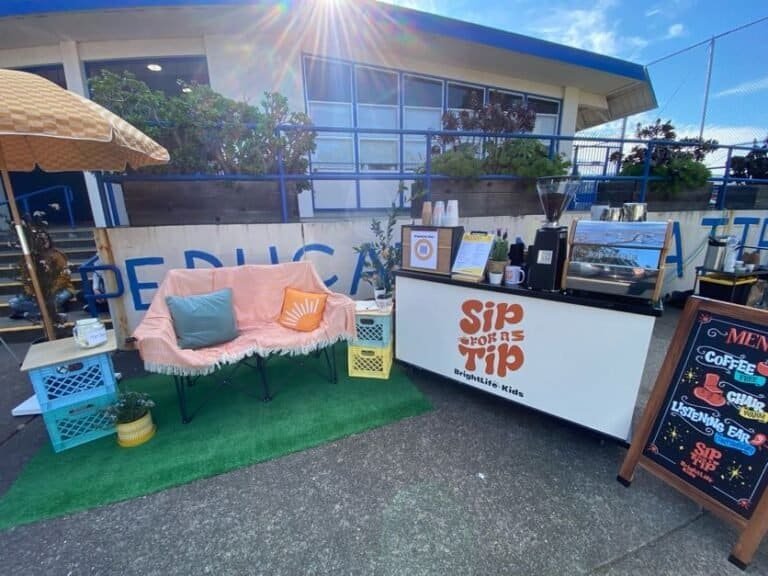 Outdoor coffee stand at Sunny Cups Coffee with seating area and menu board.