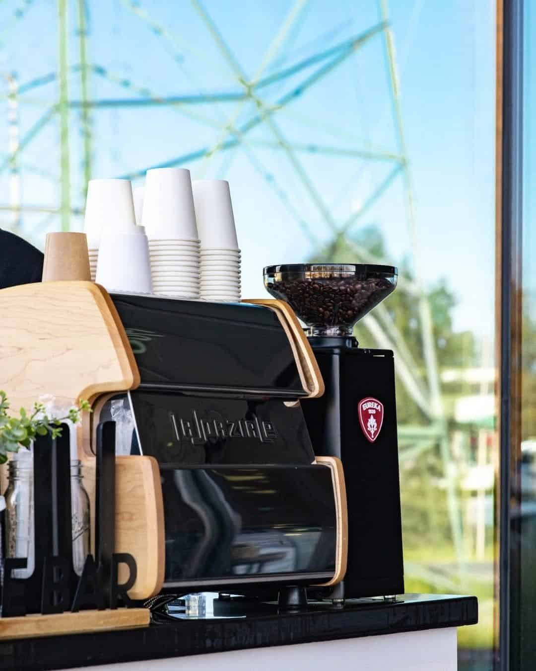 Coffee brewing station with cups and grinder at Sunny Cups Coffee.