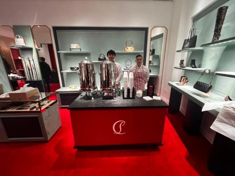 Charming coffee station with baristas preparing beverages in a stylish retail setting.