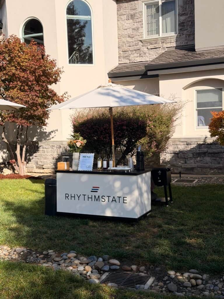 Mobile coffee catering Bay Area with espresso cart and umbrella setup.